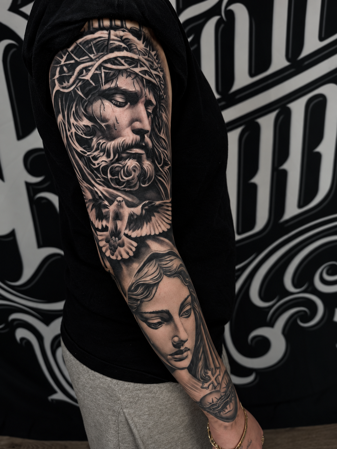 Black and grey sleeve tattoo by Scrappy