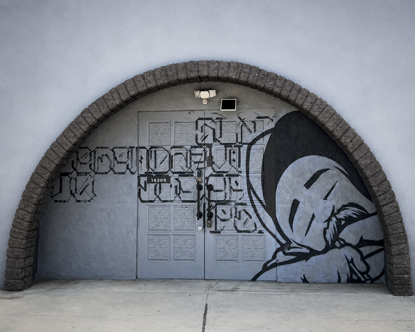 Merger Ink Studio storefront and arched entrance mural