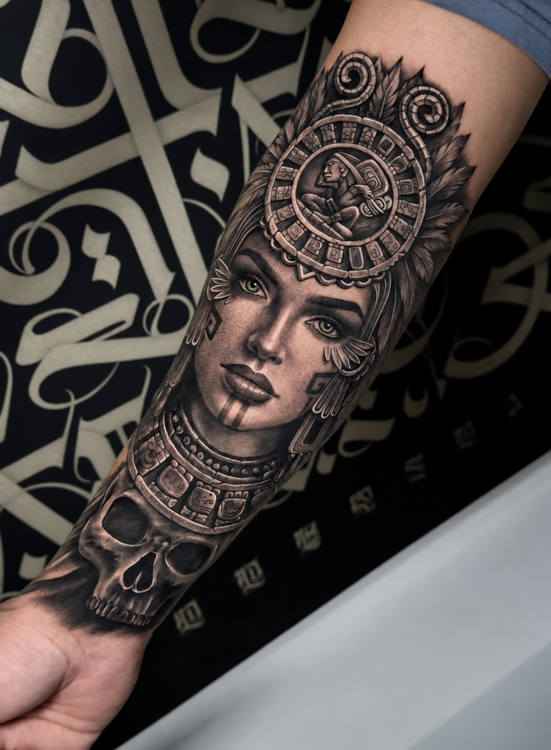 Yely black-and-grey realism tattoo of a Mesoamerican warrior portrait and skull